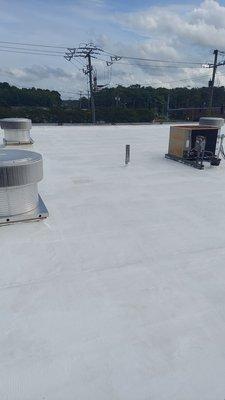 Initial layer or 10yr acrylic roof coating applied.