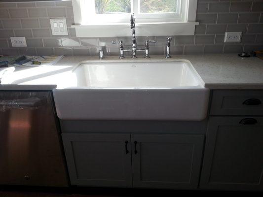 kitchen remodel with an apron sink installed.