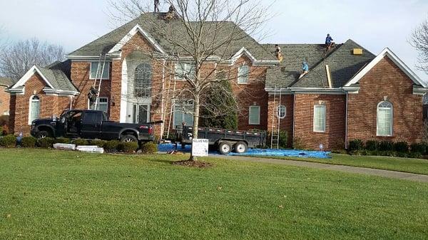 Residential tear-off in Prospect, KY. New shingles installed; the tarps on the ground serve to protect landscaping and keep the job cleaner.