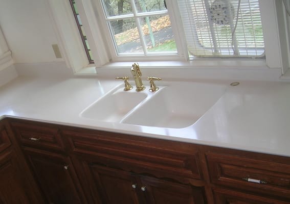 This customer wanted to change this sink into a large farm style sink.  The beauty of solid surface is that it is possible.