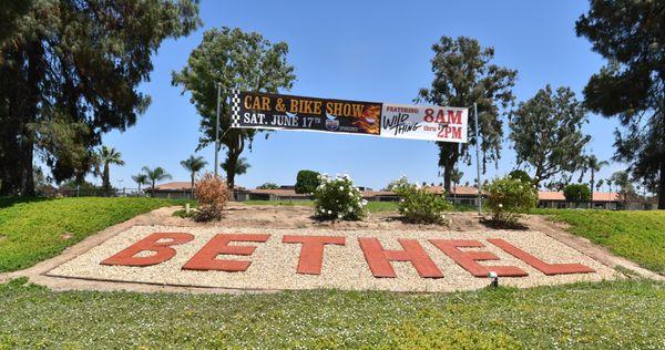 The corner of Van Buren Blvd. & Cleveland Ave with a banner for our annual car show