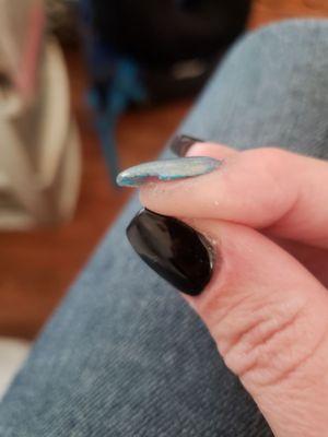 Jagged uneven edges on my nails, as well as paint and acrylic left on my finger after leaving salon