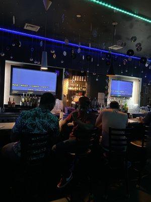 Bar with karaoke screens.