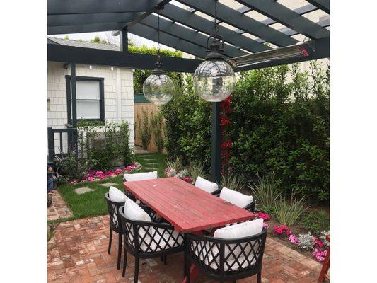 Overhead pergola with large pendant lights and heat lamps