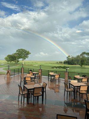 A rainbow over the golf course and outdoor patio