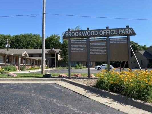 The big sign for the Brookwood Office Park and Stillpoint Massage & Bodywork Studio entrance in the background.