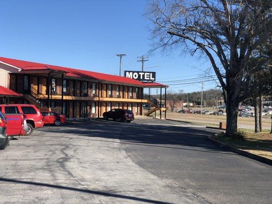 Exterior view and parking lot of Ingleside Motel.