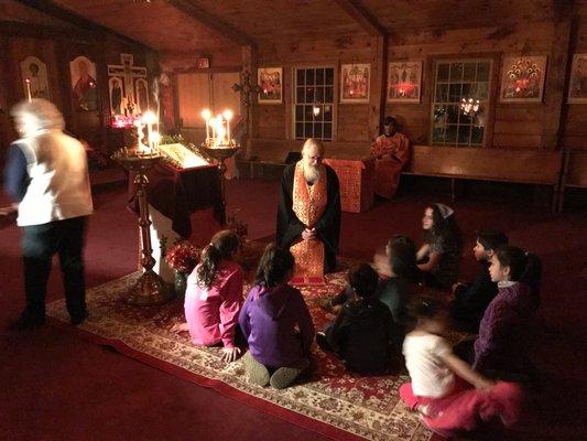 Fr. John talking with some of our parish youth on the eve of St. Nicholas Day.