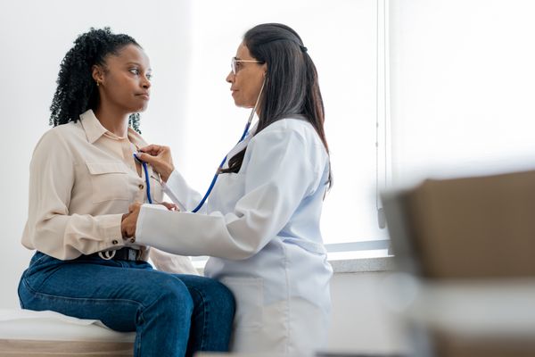 Female physician giving a check up.