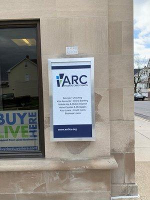 New sign on front of building listing products and services.