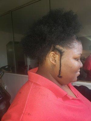 A high puff with two braids on the side