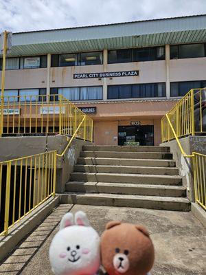 Front entrance from the sidewalk... go up the stairs and cross the parking lot