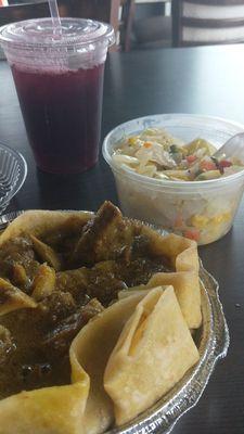 Curry goat with roti, cabbage, sorrel drink