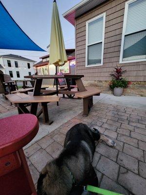 Seating area with shade sail and ambient lighting.