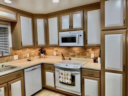 New kitchen - painted lowers with new raise panel doors, some have slide outs.  New uppers.  Partial shot of the new pantry.