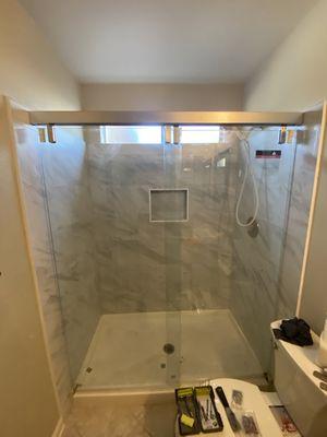 PVC Pan with Tile Shower Surround and a Brushed Metal Sliding Glass Door