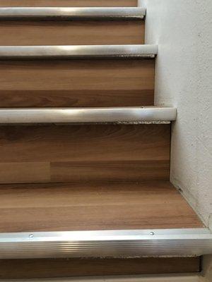 The stair tread is viable under LVP... not to mention the ugly toe kick because the flooring was a HD special with no toes.