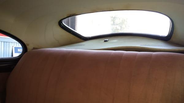 Ruined rear deck and headliner caused by leaking window John installed.