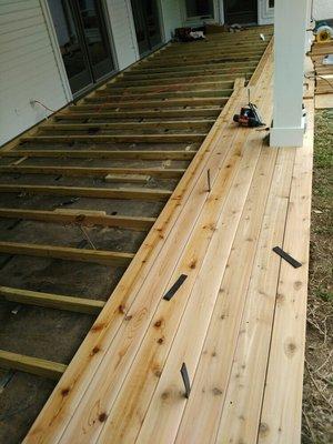 Here we are installing the cedar deck boards. This was a simple deck job. But still beautiful!