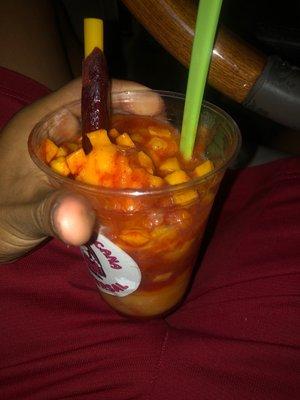 Mangoniada ice cream with mango bits and chamoy and tamarindo stick