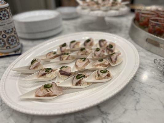 Garlic Seared Hamachi sushi bite with serrano slice and ponzu drizzle