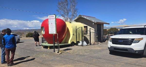 Cute little food truck stall with parking and seating in the background