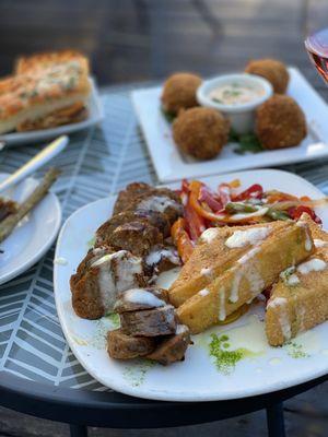 Sausage with peppers and polenta and Artichoke lollipops in the back