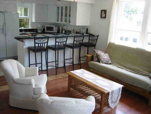 This is the living room looking into the kitchen. See the breakfast bar and stools?