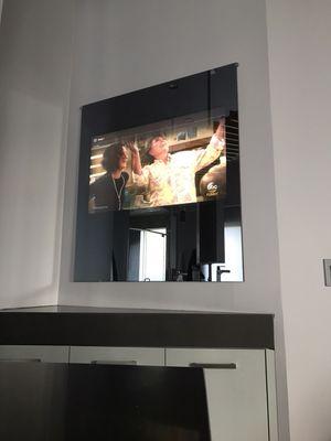 A TV behind the mirror! Now that's a bathroom!