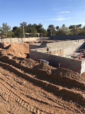 This massive 8,000 square foot basement being backfilled in lifts for a solid foundation.