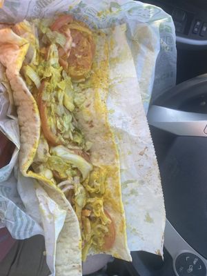 Waaay too much mustard, complete mess, it's not cut in half these people have no clue how to make a sandwich.