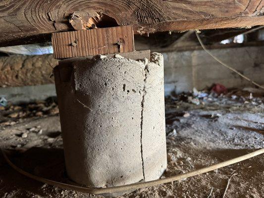 Concrete support on a raised foundation dwelling.