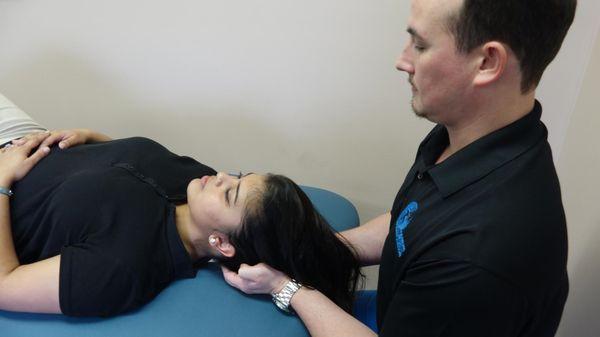 Dr. Jake using soft tissue technique on a patient with neck pain.