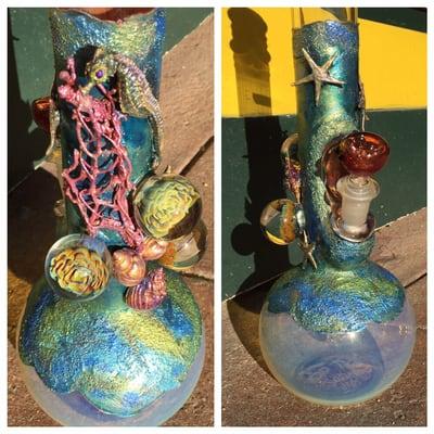 Electro formed seahorse and starfish help make this Trident glass pipe a real beauty.