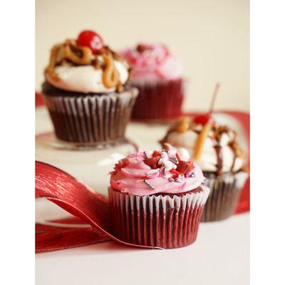 Red velvet cupcake with cream cheese frosting dyed pink for Valentine's day and Turtle Sundae cupcake