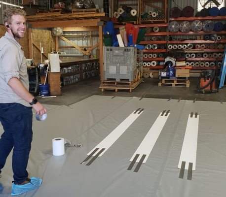 Prepping custom canopy tarp with reinforcements that will be hot air welded into the tarp!