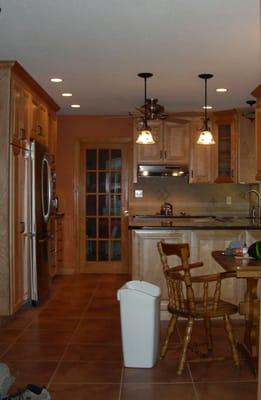 Elegant natural cherry kitchen in Avon, CT. Blackstar granite counters. Cabinets, lighting and flooring design by Plank & Vine.