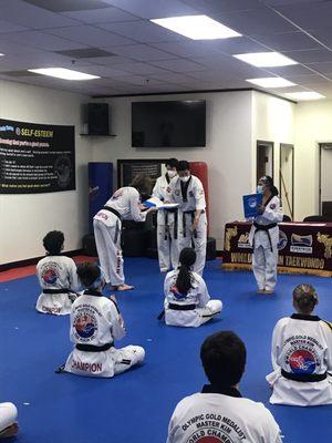 Master Kim presenting Black Belt Level testing certificate