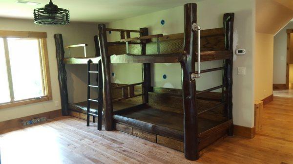 Rustic bunk beds made with trees from the Treehouse Lernign Center.