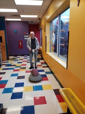 Stripping and waxing,  buffing tile floors.