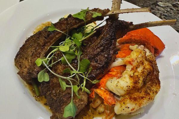 Pan seared lamb chops on top of garlic truffle mashed potatoes with a broiled lobster tail