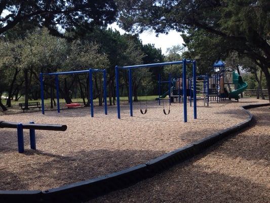 Unique see-saw, swings and larger playscape.