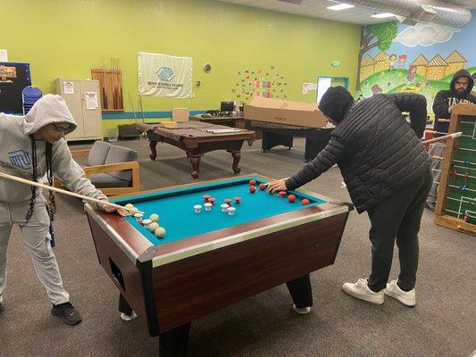 New bumper pool table being tested by our wonderful staff- yep, this game is lit!