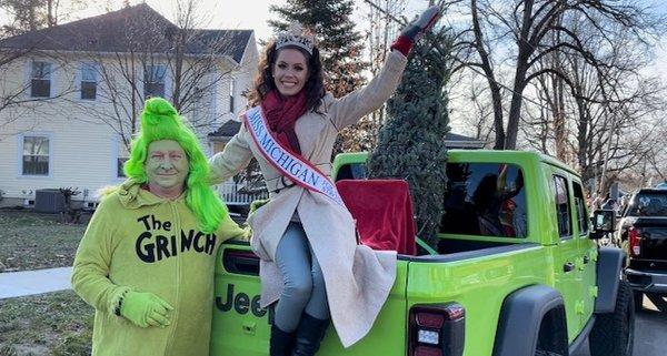 Miss Michigan and the Grinch, it's really Hank from Hank's Heating and Cooling!, representing Graff at the Rockford Christmas Parade.