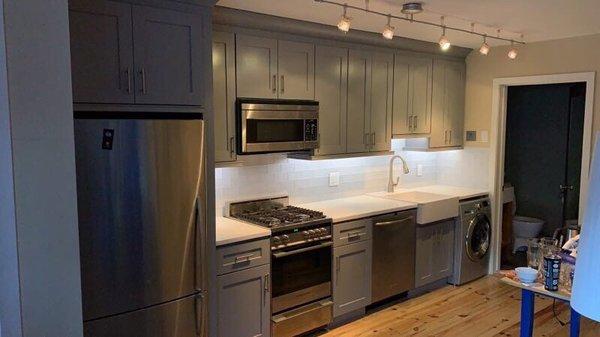 Shaker style cabinets in gray, with under cabinet lighting. We are in love!