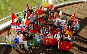 Young, enthusiastic students proudly carrying their country's flag in a display of unity, respect and their desire to learn.