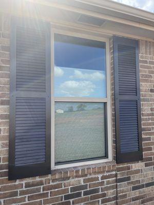 Finished shutters mounted to brick.