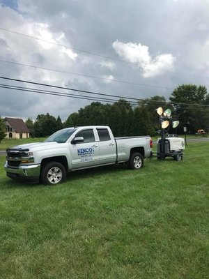 setting up light towers on football field.