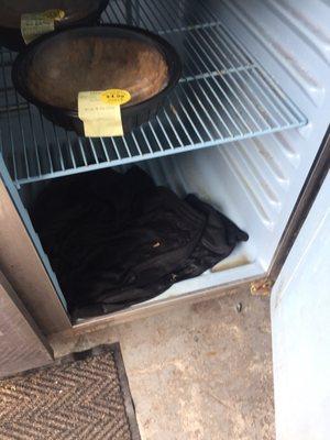 Pair of wet pants in the fridge where local stores donate their expired products...