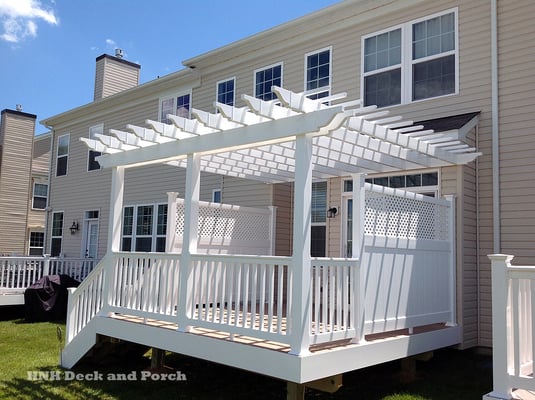 Vinyl deck using Clubhouse cobblestone decking and Longevity white railing and pergola.